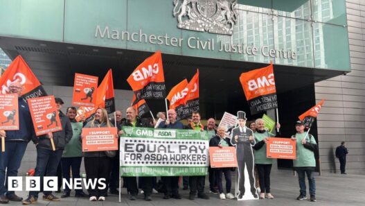 Asda workers hold rally as equal pay case begins in Manchester