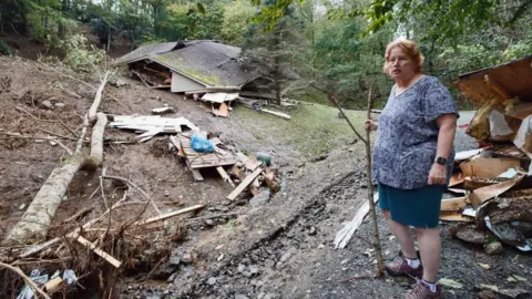 Reuters Meta Gatschenberger surveys the remains of her collapsed and destroyed house in North Carolina