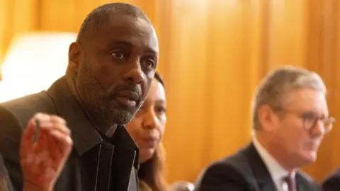 Reuters Hollywood star Idris Elba (left) speaks at the 10 Downing Street knife crime summit with prime minister Keir Starmer (right)