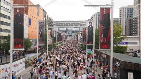 PA Media Fans gather outside Wembley Stadium in north west London, ahead of a Taylor Swift's Eras Tour concert.