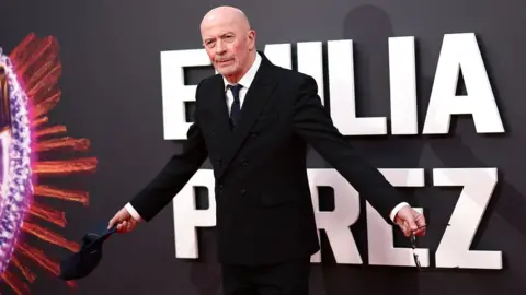 Getty Images French film director Jacques Audiard poses on the red carpet upon arrival to attend the Gala screening of "Emilia Perez" at the Royal Festival Hall, during the 2024 BFI London Film Festival in London, on October 11, 2024