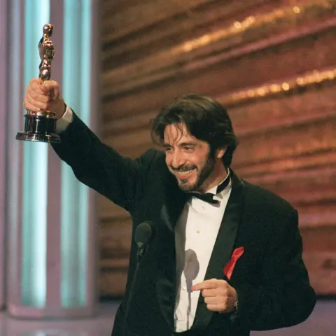 Getty Images Pacino at the 1993 Academy Awards where he won his first and only Oscar for his performance in Scent of a Woman - he is smiling and holding the statuette aloft in one hand