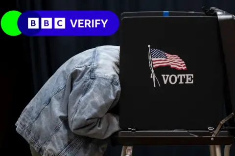 Getty Images Person filling out a ballot in a voting booth