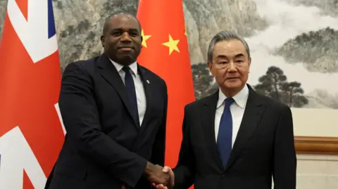 Reuters Foreign Secretary David Lammy and Chinese Foreign Minister Wang Yi shake hands