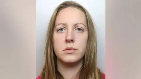 Cheshire Constabulary A police mugshot of Lucy Letby, who has long straight blonde hair and looks into the camera with a blank expression