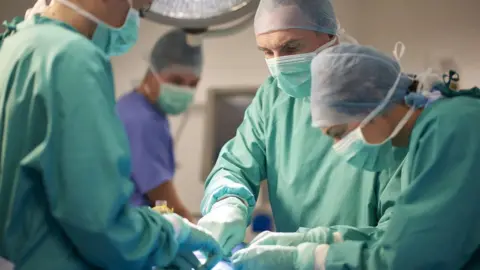 Getty Images Surgeons in an operating theatre